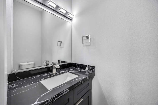 4923 Golden Forest St Unit A, Houston, TX 77091 - bathroom with toilet, a textured wall, and vanity