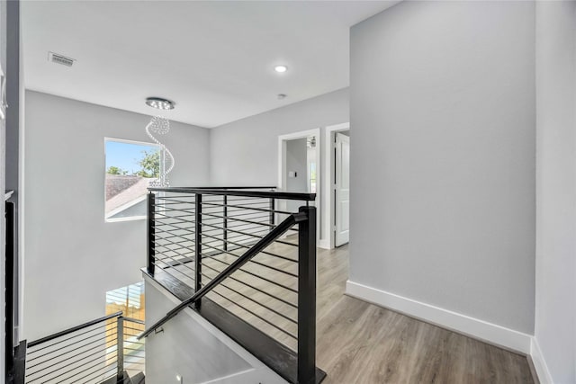 4923 Golden Forest St Unit A, Houston, TX 77091 - corridor with an upstairs landing, baseboards, a chandelier, light wood finished floors, and recessed lighting
