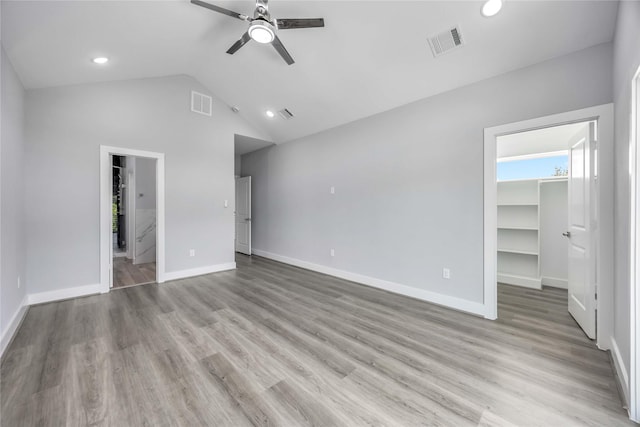 4923 Golden Forest St Unit A, Houston, TX 77091 - unfurnished bedroom with a walk in closet, vaulted ceiling, baseboards, light wood-style floors, and a closet