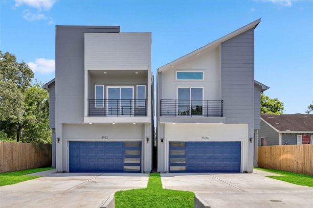 4923 Golden Forest St Unit A, Houston, TX 77091 - contemporary house featuring a balcony, an attached garage, and driveway
