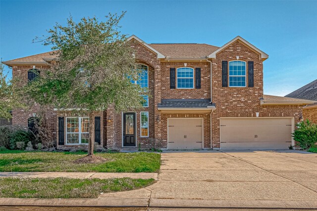 30806 Academy Trace Dr, Spring, TX 77386 - view of front of home featuring roof with shingles, concrete driveway, brick siding, and an attached garage