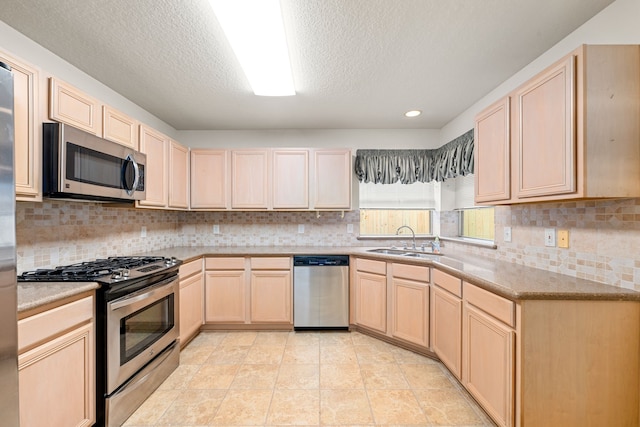 3031 W Cedar Sun Trl, Katy, TX 77449 - kitchen with stainless steel appliances, light brown cabinetry, a sink, decorative backsplash, and a textured ceiling