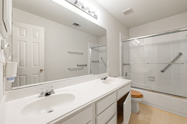 3031 W Cedar Sun Trl, Katy, TX 77449 - full bathroom with toilet, double vanity, shower / bath combination with glass door, tile patterned floors, and a textured ceiling