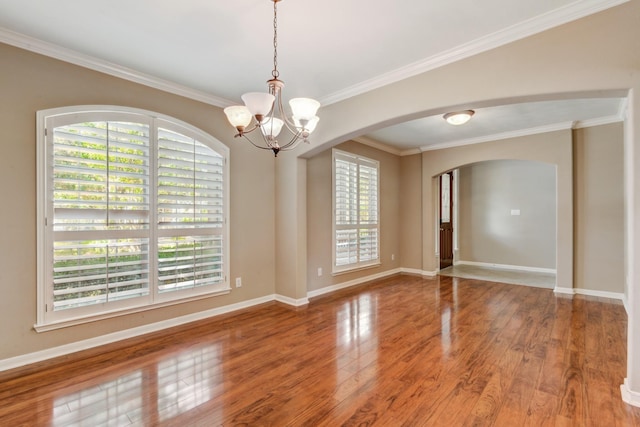 10502 Ginger Gln, Missouri City, TX 77459 - spare room with arched walkways, a chandelier, wood finished floors, baseboards, and ornamental molding