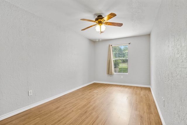 36 Jamaica Ln, Normangee, TX 77871 - empty room with a textured wall, light wood-style floors, a ceiling fan, and baseboards