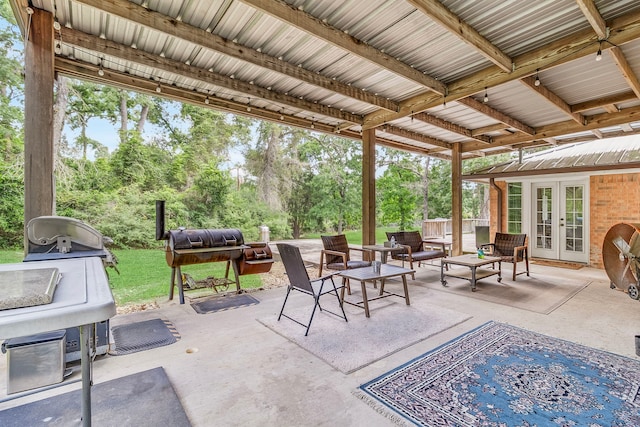 36 Jamaica Ln, Normangee, TX 77871 - view of patio / terrace featuring french doors, outdoor lounge area, view of wooded area, and a grill
