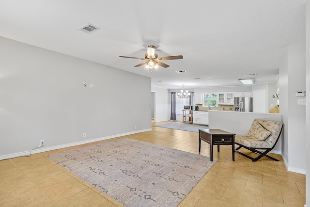36 Jamaica Ln, Normangee, TX 77871 - living area with a chandelier, a ceiling fan, baseboards, and light tile patterned floors