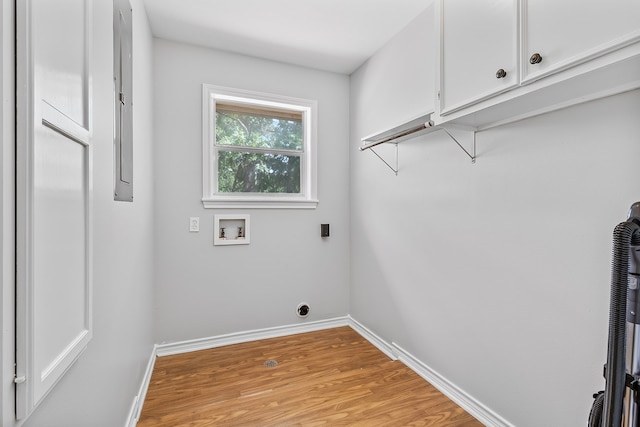 36 Jamaica Ln, Normangee, TX 77871 - laundry room featuring cabinet space, hookup for a washing machine, light wood-type flooring, and baseboards