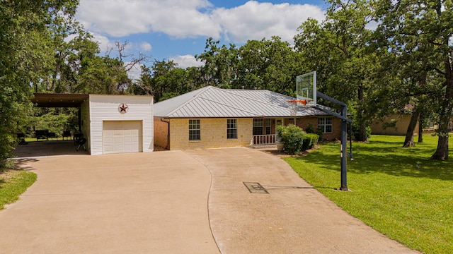36 Jamaica Ln, Normangee, TX 77871 - view of front of home with driveway, a front yard, an outbuilding, a carport, and stone siding