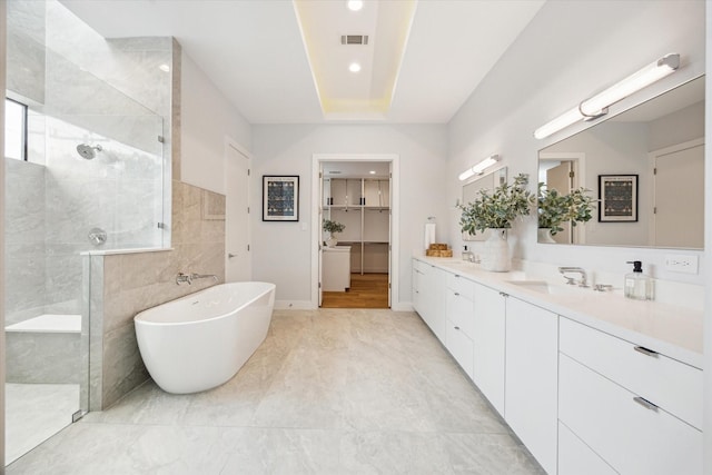 3851 Merrick St, Houston, TX 77025 - bathroom featuring a walk in shower, double vanity, a freestanding tub, recessed lighting, and baseboards