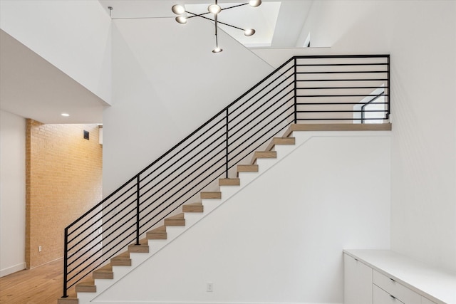 3851 Merrick St, Houston, TX 77025 - stairs with wood finished floors and a chandelier
