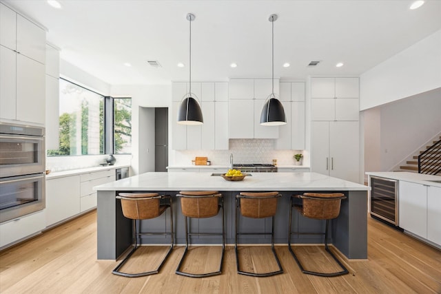 3851 Merrick St, Houston, TX 77025 - kitchen with modern cabinets, wine cooler, double oven, and recessed lighting