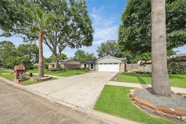 9607 Rumbling Wood Ln, Houston, TX 77086 - ranch-style home with concrete driveway and a garage