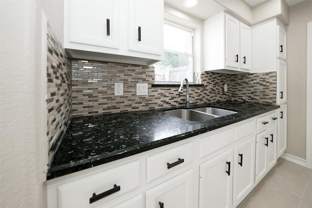 9607 Rumbling Wood Ln, Houston, TX 77086 - kitchen with a sink, tasteful backsplash, and white cabinetry