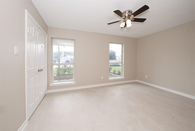 9607 Rumbling Wood Ln, Houston, TX 77086 - empty room with a ceiling fan and baseboards