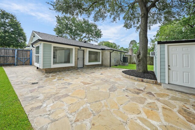 9607 Rumbling Wood Ln, Houston, TX 77086 - view of patio / terrace with a gate and central AC