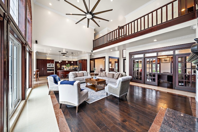 3818 Foolish Pleasure Ct, Richmond, TX 77406 - living room with a towering ceiling, hardwood / wood-style flooring, ornamental molding, ceiling fan, and french doors