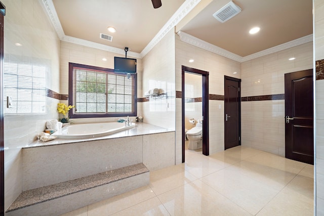 3818 Foolish Pleasure Ct, Richmond, TX 77406 - bathroom with ornamental molding, tile walls, tile patterned floors, a bath, and toilet