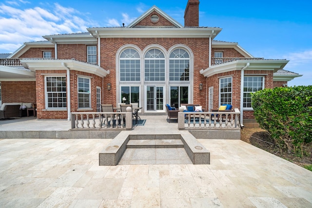 3818 Foolish Pleasure Ct, Richmond, TX 77406 - back of house with an outdoor living space, a patio area, and a chimney
