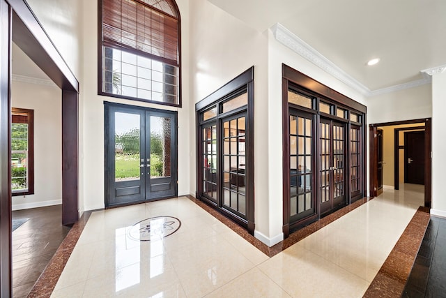 3818 Foolish Pleasure Ct, Richmond, TX 77406 - foyer entrance featuring french doors, inlaid floor details, ornamental molding, baseboards, and plenty of natural light