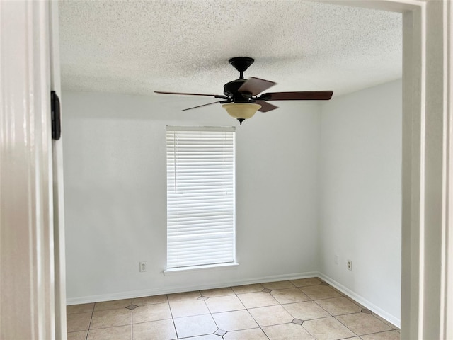 12550 Whittington Dr Unit 712, Houston, TX 77077 - spare room featuring ceiling fan, light tile patterned floors, baseboards, and a textured ceiling