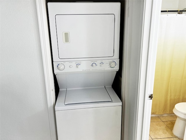 12550 Whittington Dr Unit 712, Houston, TX 77077 - laundry area with stacked washer and clothes dryer and tile patterned floors