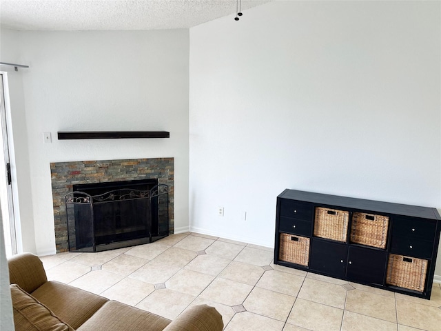 12550 Whittington Dr Unit 712, Houston, TX 77077 - tiled living area featuring a fireplace and a textured ceiling