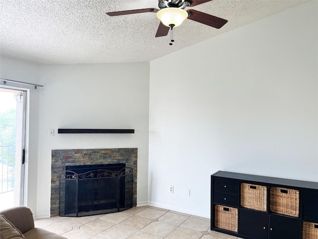 12550 Whittington Dr Unit 712, Houston, TX 77077 - living room with a textured ceiling, ceiling fan, light tile patterned floors, and a stone fireplace