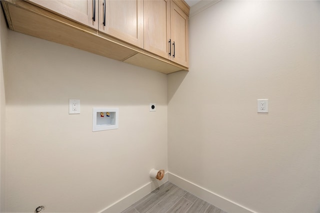1041 Gardendale Dr, Houston, TX 77018 - washroom featuring cabinet space, washer hookup, baseboards, electric dryer hookup, and light wood-style floors