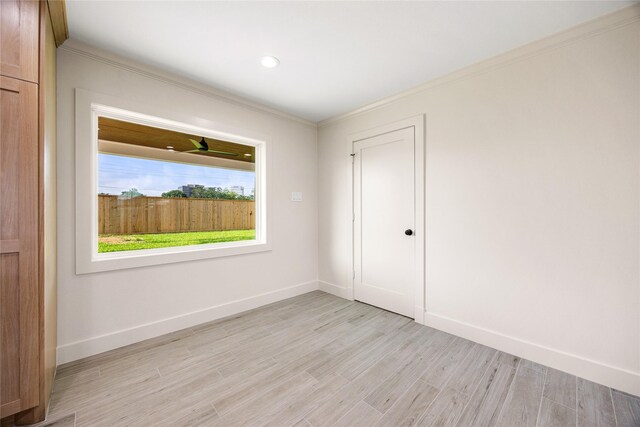 1041 Gardendale Dr, Houston, TX 77018 - empty room featuring crown molding, light wood-style floors, and baseboards