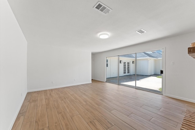 322 N Wilcrest Dr, Houston, TX 77079 - spare room featuring light wood-style flooring, baseboards, and french doors