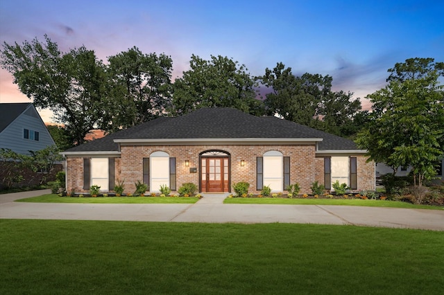 322 N Wilcrest Dr, Houston, TX 77079 - view of front of house featuring a lawn, brick siding, and a shingled roof