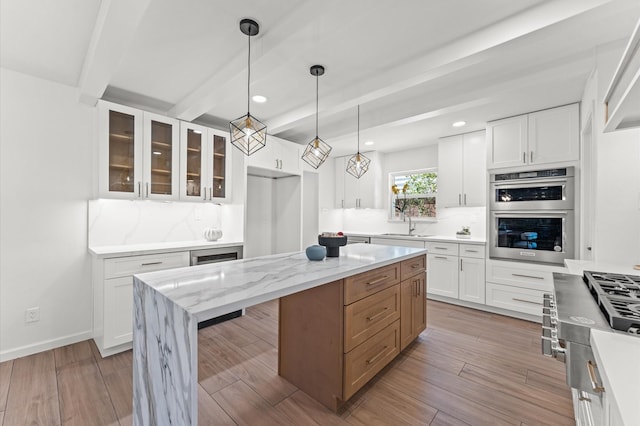 322 N Wilcrest Dr, Houston, TX 77079 - kitchen featuring beamed ceiling, glass insert cabinets, backsplash, white cabinetry, and recessed lighting