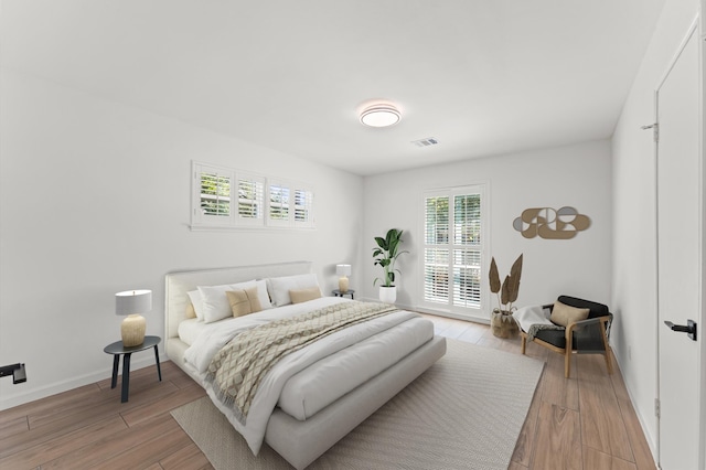 322 N Wilcrest Dr, Houston, TX 77079 - bedroom with light wood finished floors and baseboards