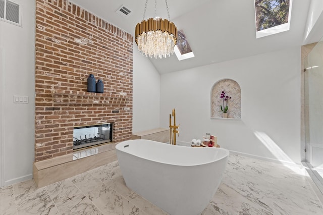 322 N Wilcrest Dr, Houston, TX 77079 - bathroom featuring marble finish flooring, a brick fireplace, a freestanding bath, a skylight, and a shower with door