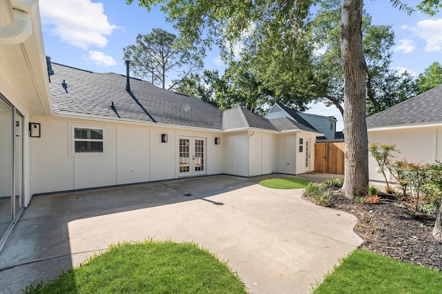 322 N Wilcrest Dr, Houston, TX 77079 - back of property with french doors, board and batten siding, a shingled roof, and a patio
