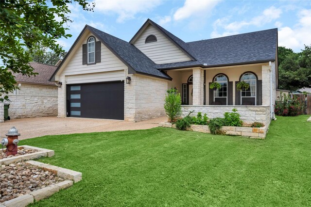 312 Fox Xing, Burnet, TX 78611 - view of front of house with a shingled roof, stone siding, driveway, and a garage