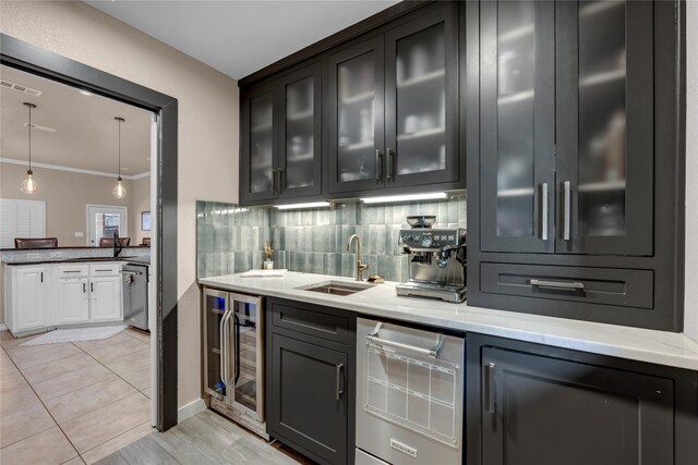312 Fox Xing, Burnet, TX 78611 - bar area featuring beverage cooler, a sink, crown molding, hanging light fixtures, and stainless steel dishwasher