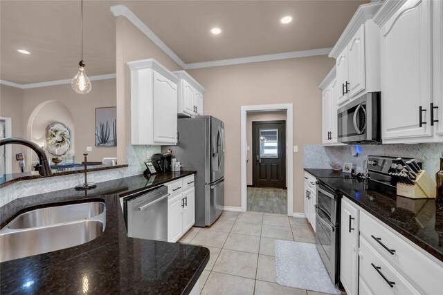 312 Fox Xing, Burnet, TX 78611 - kitchen featuring stainless steel appliances, a sink, backsplash, ornamental molding, and white cabinets