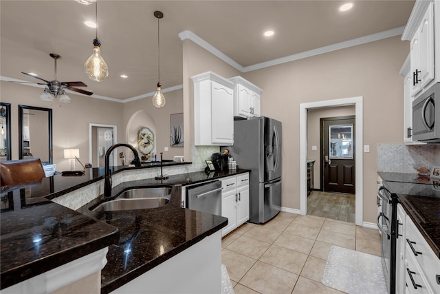 312 Fox Xing, Burnet, TX 78611 - kitchen with a sink, appliances with stainless steel finishes, ceiling fan, decorative backsplash, and white cabinets