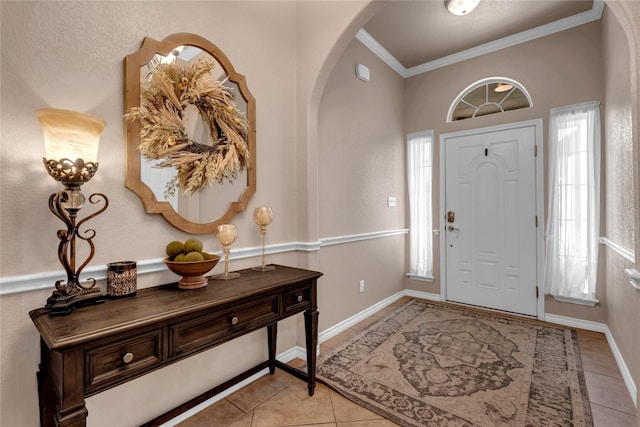 312 Fox Xing, Burnet, TX 78611 - foyer entrance with arched walkways, ornamental molding, light tile patterned flooring, and healthy amount of natural light