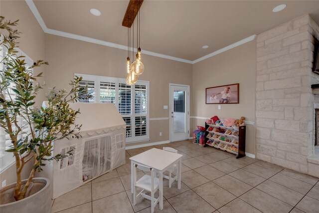 312 Fox Xing, Burnet, TX 78611 - dining space with light tile patterned flooring, ornamental molding, and a stone fireplace