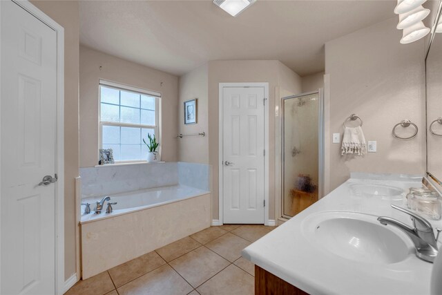312 Fox Xing, Burnet, TX 78611 - full bath featuring a stall shower, tile patterned flooring, a bath, and double vanity