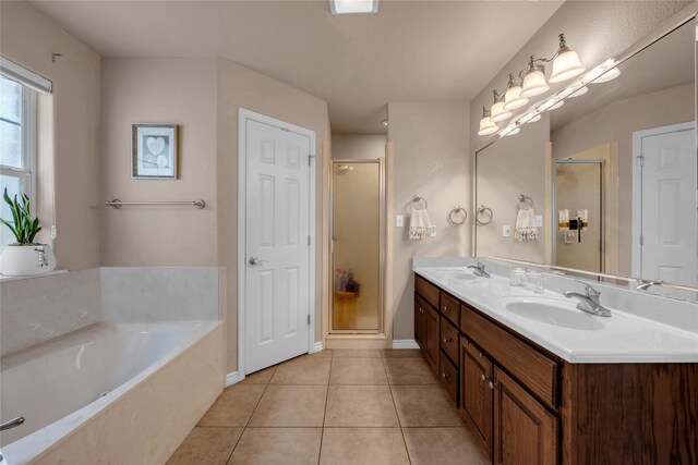 312 Fox Xing, Burnet, TX 78611 - bathroom featuring tile patterned flooring, a garden tub, a shower stall, and double vanity