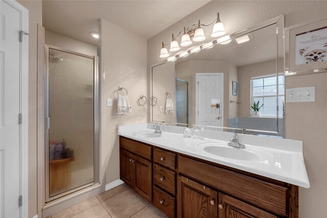 312 Fox Xing, Burnet, TX 78611 - bathroom with a stall shower, tile patterned floors, and double vanity