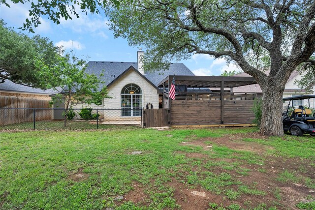 312 Fox Xing, Burnet, TX 78611 - rear view of house with a chimney and a gate