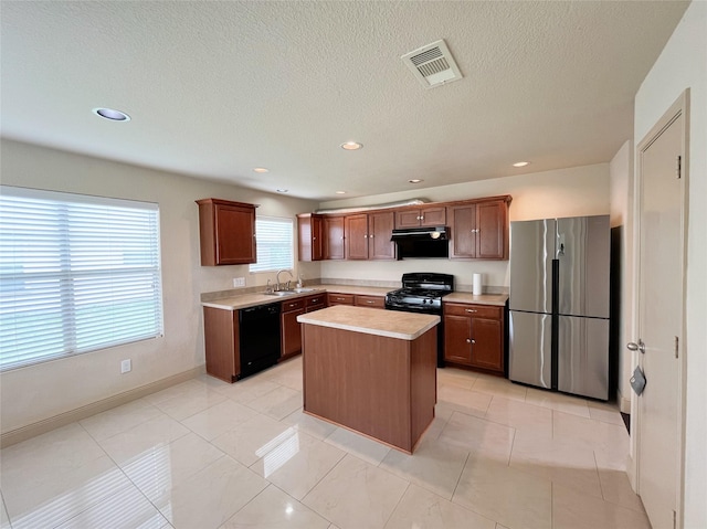 20516 Hawkins Manor Ln, Katy, TX 77449 - kitchen featuring black appliances, exhaust hood, a sink, light countertops, and a center island
