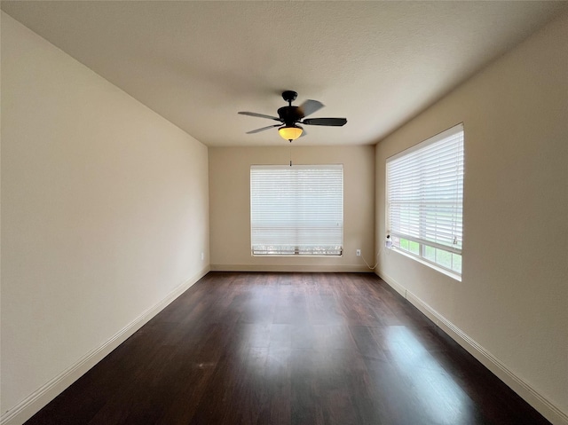 20516 Hawkins Manor Ln, Katy, TX 77449 - unfurnished room with dark wood-type flooring, baseboards, and a ceiling fan
