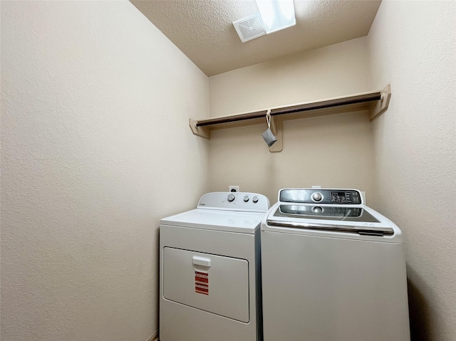 20516 Hawkins Manor Ln, Katy, TX 77449 - washroom with washing machine and dryer and a textured ceiling