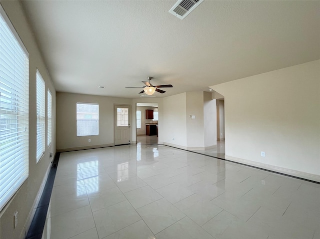 20516 Hawkins Manor Ln, Katy, TX 77449 - unfurnished room featuring a ceiling fan, baseboards, a textured ceiling, and light tile patterned flooring